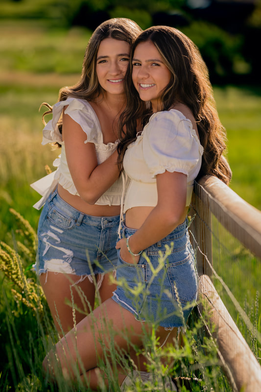 two girls wearing white tops and jean shorts outside senior photoshoot inspiration for spring broomfield colorado sarah lindsay photography